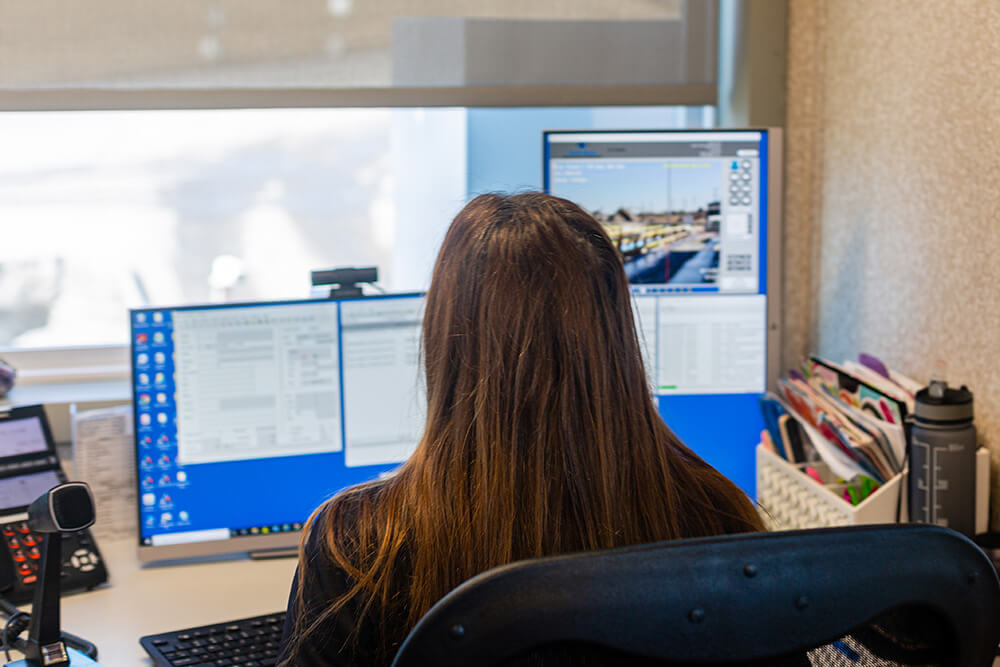 man sitting at desktop computer using apex