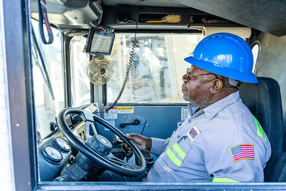 man in truck cab touching a touch screen tablet 